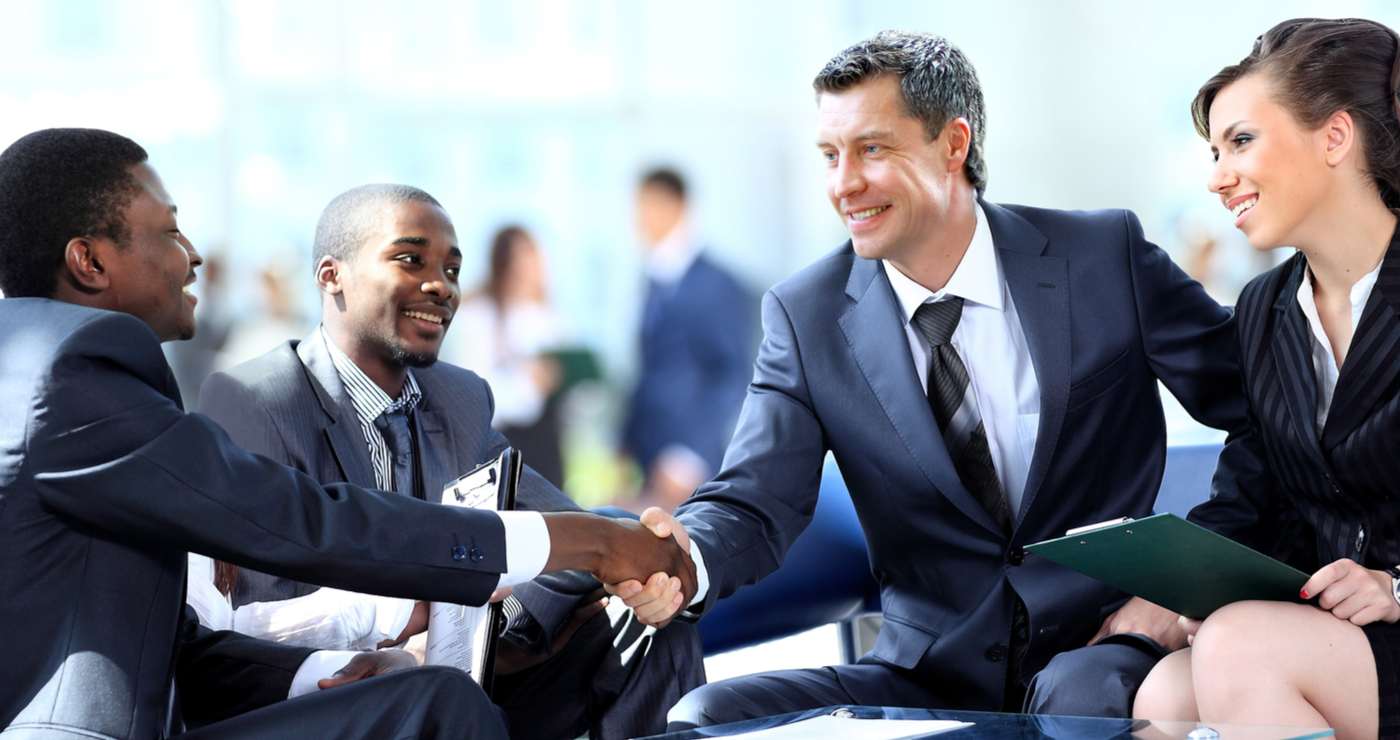 Sales professionals celebrating successful business partnership