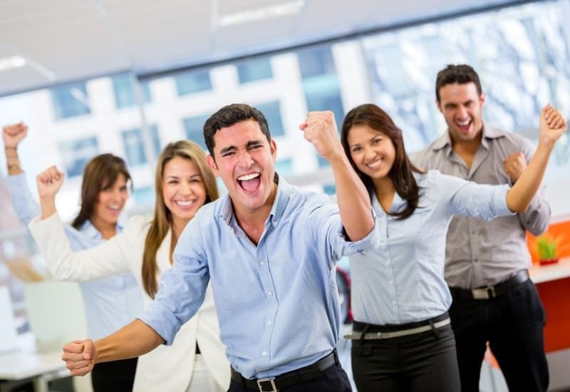Excited sales team celebrating success